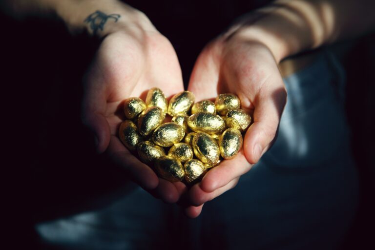 Hands holding golden eggs